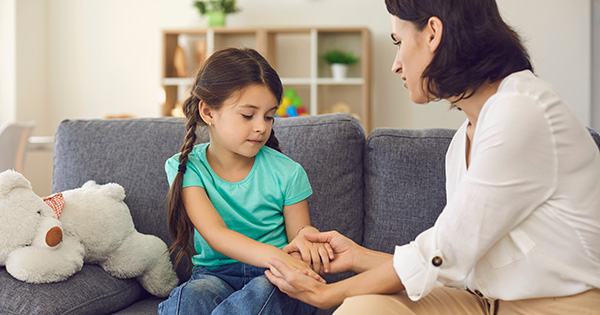 Mom holding daughter's hands.