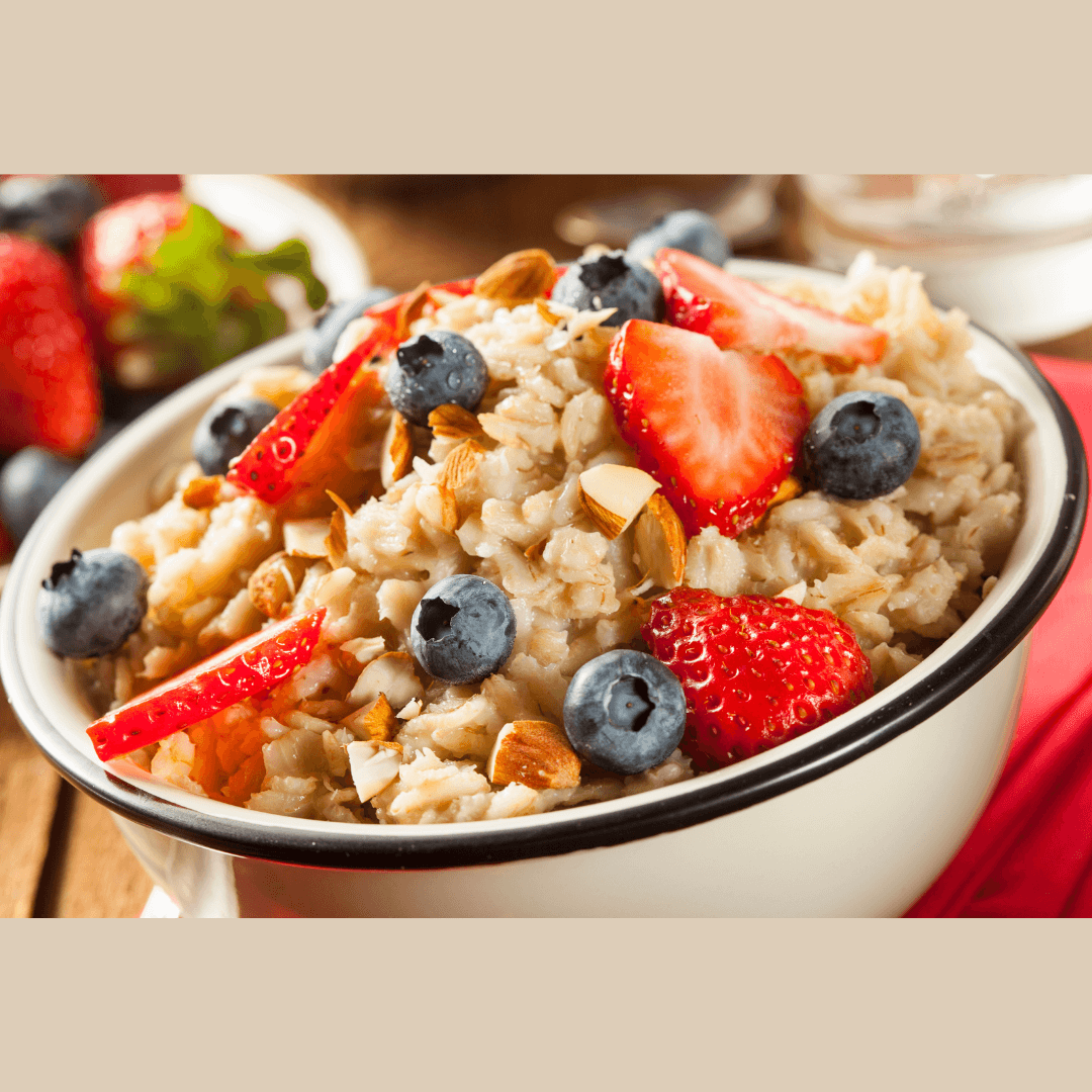 a bowl of oatmeal with strawberries and assorted nuts.