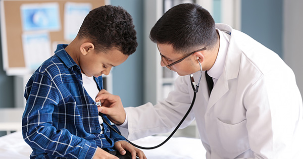 Provider examining young patient.