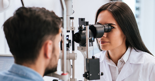 Provider examining patients eyes. 