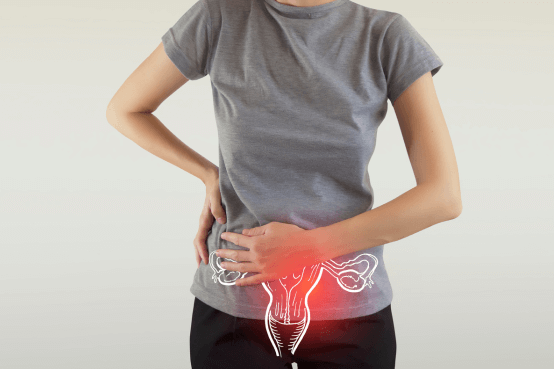 A woman holding her lower belly. There is an ovaries animation showing where it is hurting the woman in a red bubble.