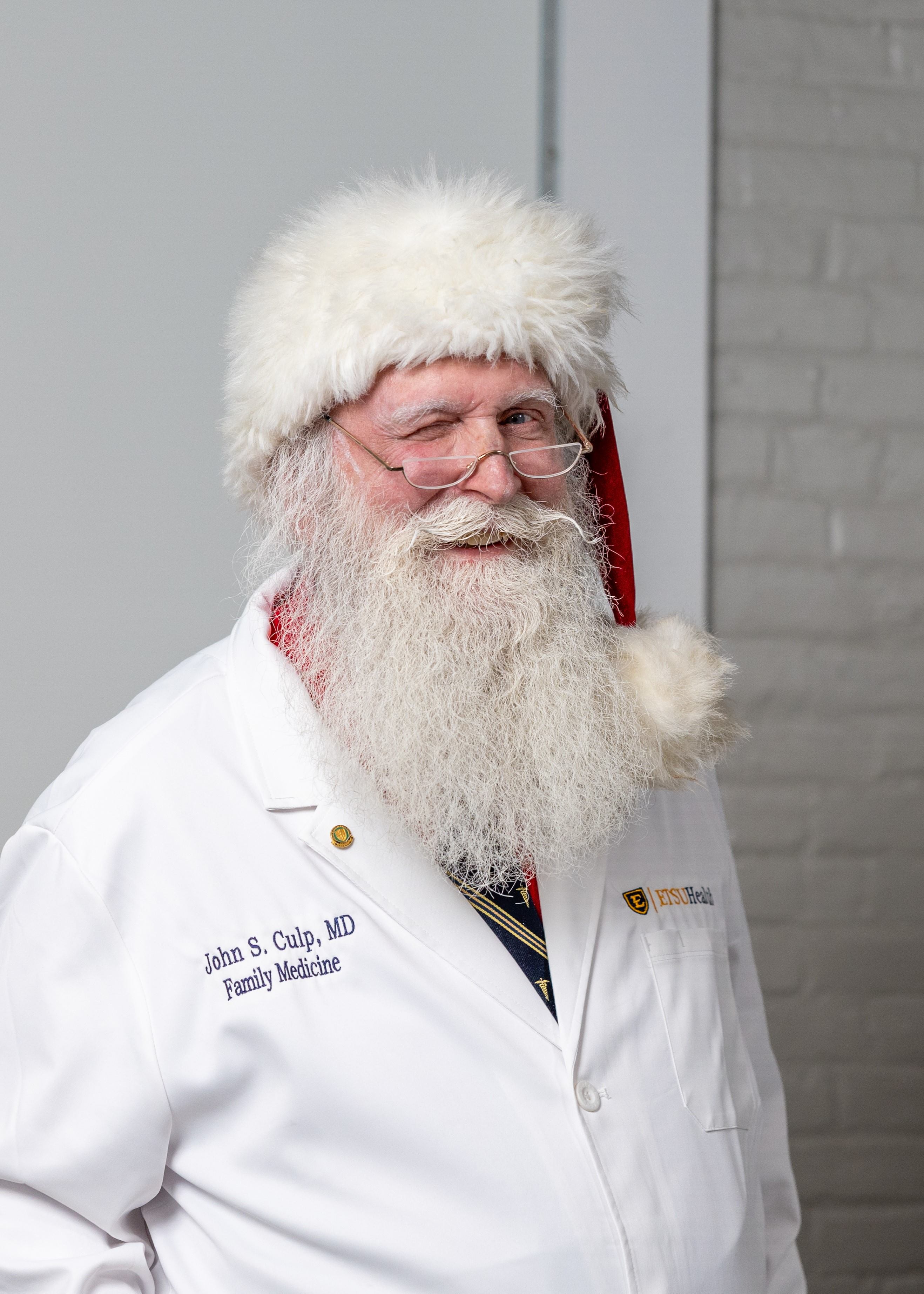 Dr. John Culp wearing Santa hat